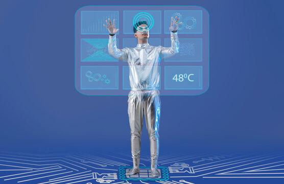 A man wearing silver,futuristic  clothes working on a virtual screen. A future technology concept