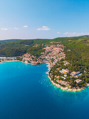 Obraz premium drone photograph of Rabac surrounded by lush green forests and the clear blue Adriatic Sea