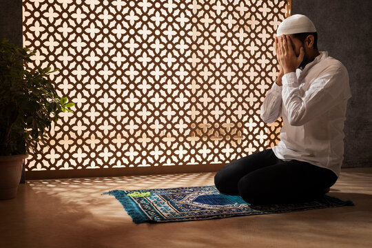 Portrait of a Muslim man praying at home
