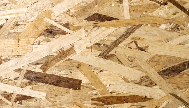 OSB oriented strand board texture background with compressed wooden flakes chipboard panel macro photo