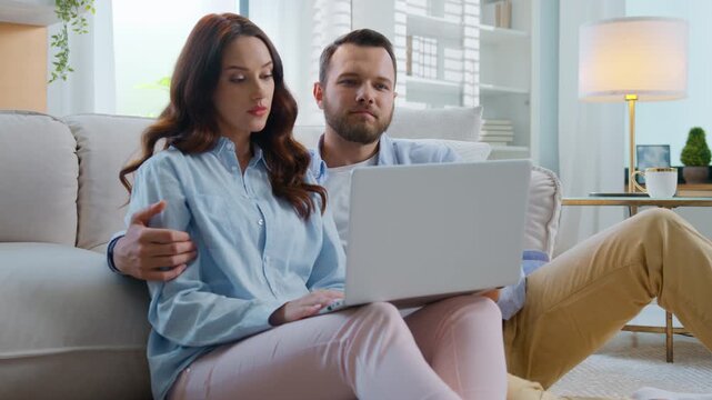 Serious Caucasian family choosing shopping goods together man disagree woman talking typing computer difficult choice searching purchase in internet store virtual shop husband with wife at home