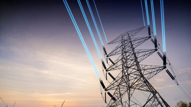 Silhouette of a high voltage electricity pylon with glowing blue digital light beams on power lines against a dramatic colorful sunset sky. Concept of smart grid and future energy
