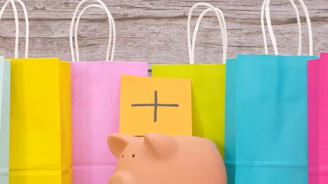 Piggy bank offers with paper inserts featuring a plus sign; paper bags for sales.