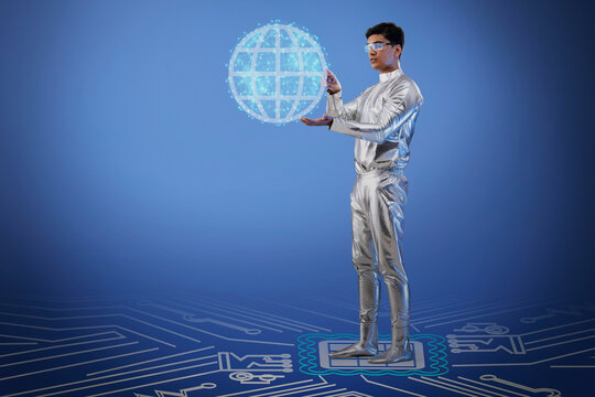 A man wearing silver,futuristic  clothes holding digital globe ,future technology concept