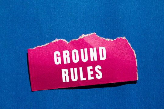 Torn pink paper with white ground rules text on a blue background, representing regulations, ethics, and policy concepts