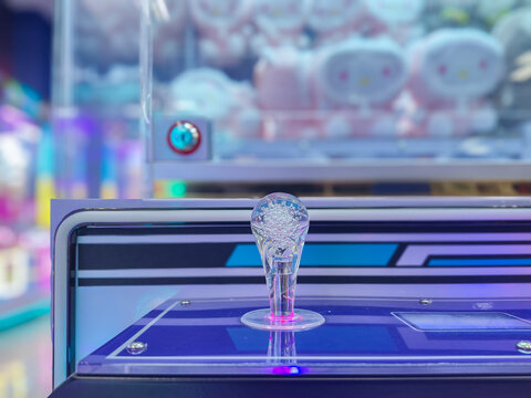 Claw Machine Joystick Close Up with Neon Glowing LED Lights in Arcade Game Room