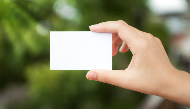 hand holding a blank business card. Hand hold white blank business card. with space for text.