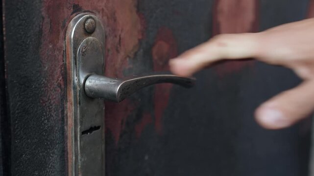 Man grabs door handle and gets electric shock