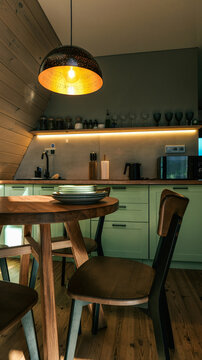 Cozy kitchen dining area with wooden table and chairs under a decorative pendant light