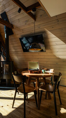 Obraz premium Cozy wooden cabin interior with vintage record player and modern amenities