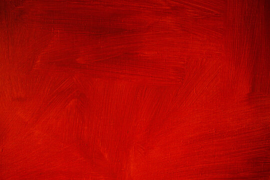 Red abstract background, painted canvas texture with brush strokes and vintage vignette effect