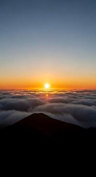 Golden Sunrise Rising Above Cloud Sea From Dark Mountain Summit