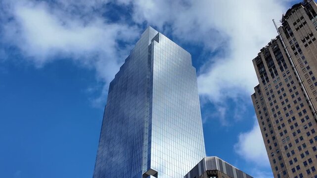 Glass skyscraper sky reflection. Sky reflection on business district city. Modern commercial architecture. Business skyscraper building. Architecture building business area. Concept of success