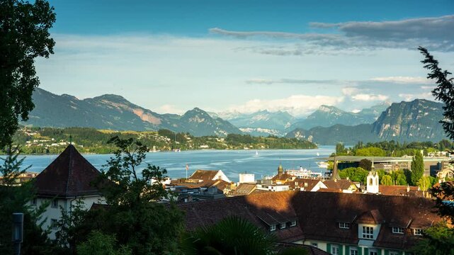Scenic time lapse of rushing clouds and moving shadows over the beautiful city of Lucerne with Mount Pilatus and Lake Lucerne in Switzerland