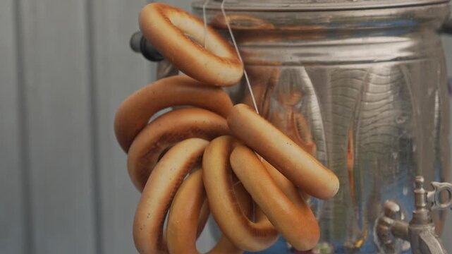 A bundle of bagels is hanging on the samovar. Folk visual art of East Slavic culture. The symbolism of Slavic culture.