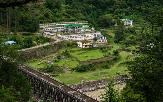 GMVN tourist guest house in Maneri, Uttarkashi, a government‑run stay in a lush hillside Himalayan village with bridge and mountain view,