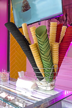 Colorful waffle ice cream cones display in a cake shop window