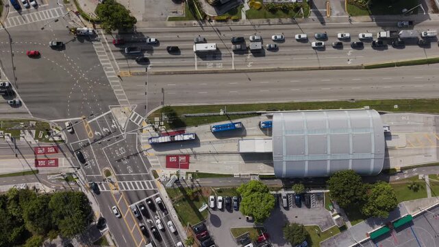 Aerial Top-Down View of Urban Transit Station with Bus Rapid Transit Lanes and City Traffic