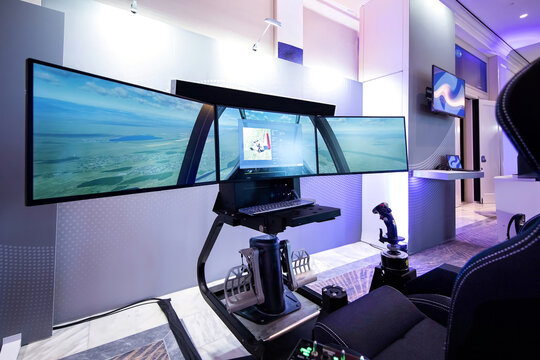 Flight Simulator Cockpit with Triple Monitor Display and Joystick Controls
