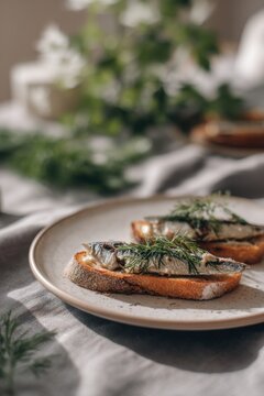 Toast with sardine and dill on ceramic plate. Appetizer with bread and fish for lunch. Traditional snack with healthy ingredient, rustic style food serving, culinary photography.