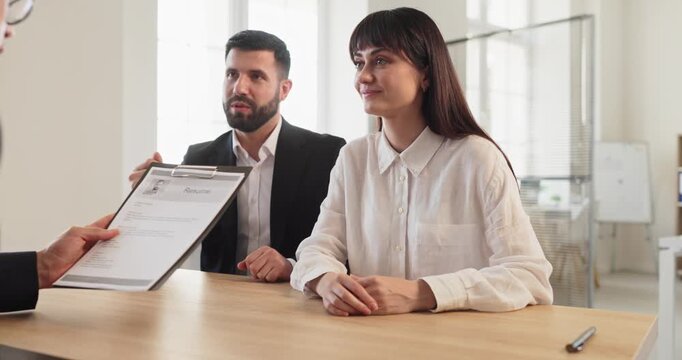 Interview candidate with recruiter reviewing resume during hiring. Job discussion in a bright office meeting as hr evaluates skills for a vacancy and fit. Clear concept of hiring decision.