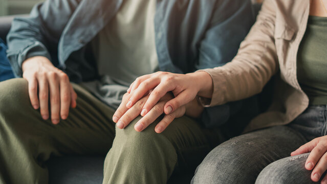 Young couple holding hands and supporting each other