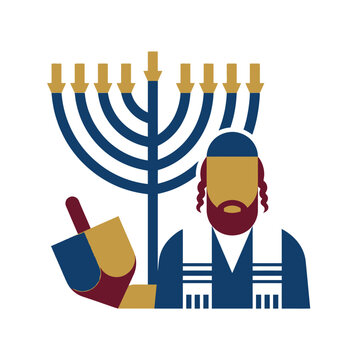 Jewish man celebrating Hanukkah with a menorah and a dreidel