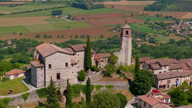 Greccio Rieti Lazio Italy 4K Drone. Parallax orbit flight around clock tower of beautiful ancient borgo village. Scenic green valley fields moving background historic b roll cinematic video asset