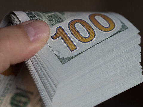Stack of 100 Dollar Bills Counted by Hand