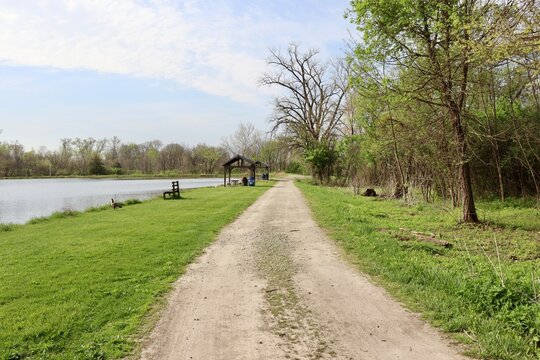 The empty gravel road in the countryside on a sunny day.