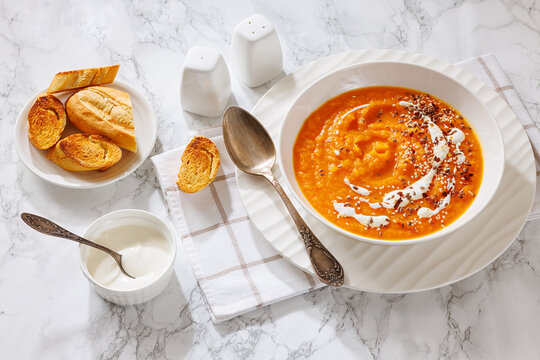spiced sweet potato soup in a white bowl