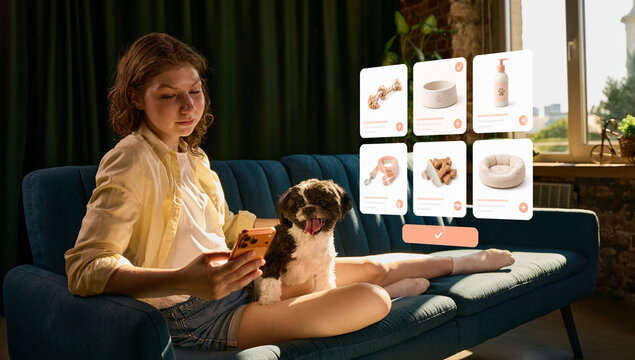 Woman comparing pet products in online catalog while sitting with small dog at home. Concept of digital shopping, pet marketplace, product comparison and ecommerce services.