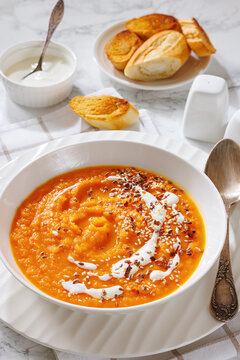 spiced sweet potato soup in a white bowl