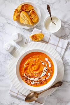 spiced sweet potato soup in a white bowl