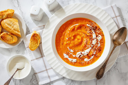 spiced sweet potato soup in a white bowl