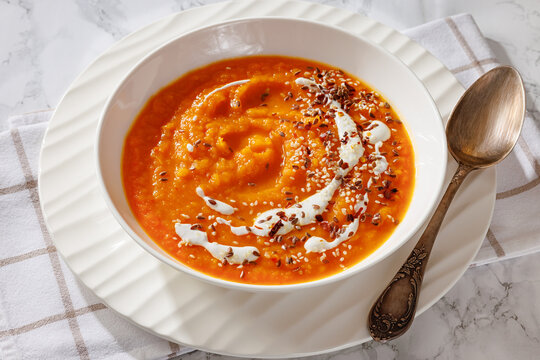 spiced sweet potato soup in a white bowl