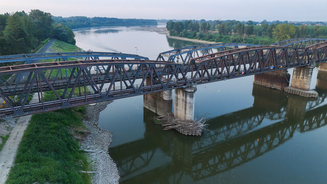 Po river bridge at Cremona Piacenza border revealing critically low water levels during 2026 heatwave drought, highlighting climate crisis impact and environmental urgency