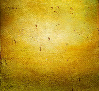 Abstract golden canvas texture background with a warm glowing light and visible linen weave, aged  gold painted surface with speckled stains. Vintage background for christmas holiday design.