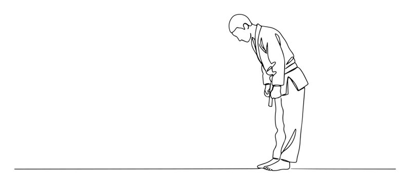 judo athlete bowing respectfully on mat