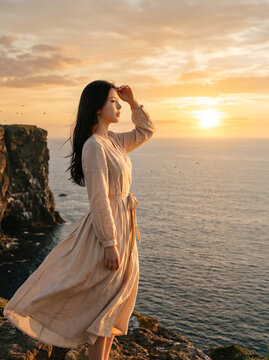 석양 바다 앞에서 머리를 넘기는 여성 / Woman Brushing Her Hair by the Sunset Sea