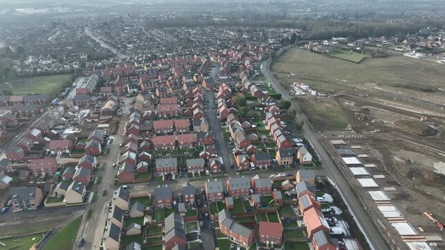 High Aerial Drone View of Dense Suburban Housing Rooftops in Barton Seagrave English Countryside