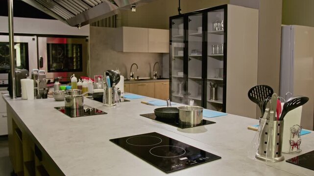 Modern culinary studio kitchen showing steam rising from pot on induction stove. Clip is perfect for restaurant promo videos or cooking school advertisements