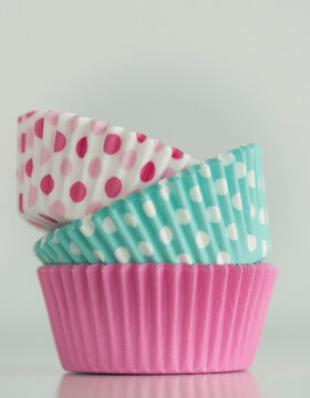 Close-up of a Stack of assorted colourful Cupcake cases on a table