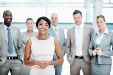 Obraz premium Smile, portrait or business woman with team in lobby for career, about us or financial conference. Consultant, group and proud finance advisor in office with ambition, corporate event or opportunity