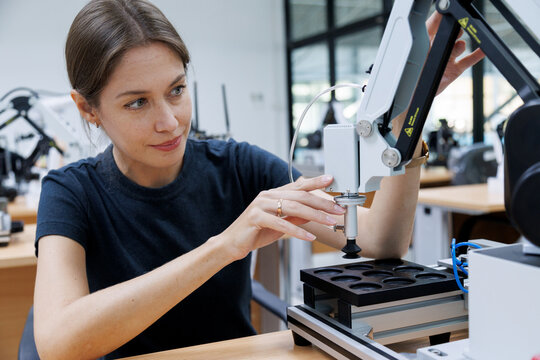Female automation machine engineer student study and inspection control robot machine in university workshop. ai robot technology new innovation trend of manufacturing in industry 5.0