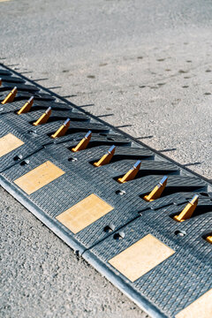 Traffic control tire killer spikes on an asphalt road