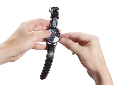 Hands adjusting black wristwatch with leather strap, isolated on transparent cutout background