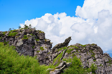 A scenic view of rocky mountain peaks and green vegetation under a bright blue sky in Shennongjia Forestry District China © AS_SleepingPanda