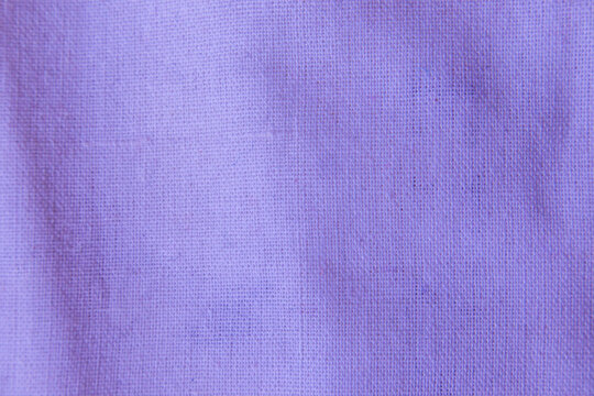 Close up purple lavender cotton linen canvas texture with woven details. Natural coarse texture for design fabric background. Rough violet crumpled burlap background.