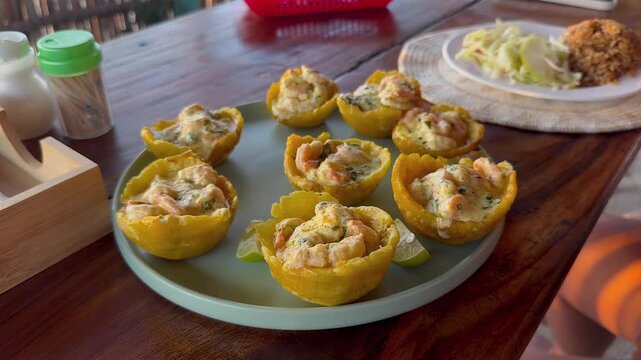 traditional colombian patacones with shrimp topping